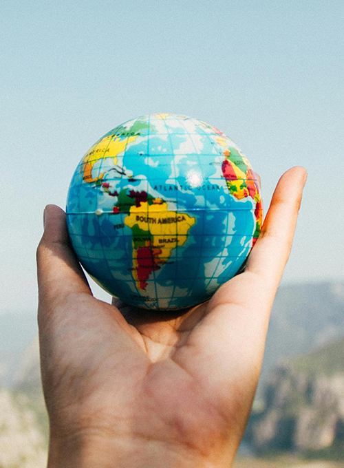 Male hand holding the globe earth